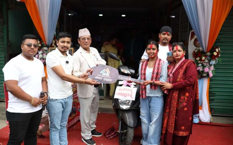 “एस.ई.ई. दिएर बसेकी खहरेकी सजिनाले पाइन त्रिमूर्ति मोबाइल हाउसको उपहार: स्कूटर।”